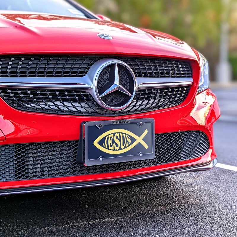Jesus Fish Ichthys front license plate on a red car