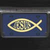 A close up of the Jesus Fish Ichthys front license plate on a black car