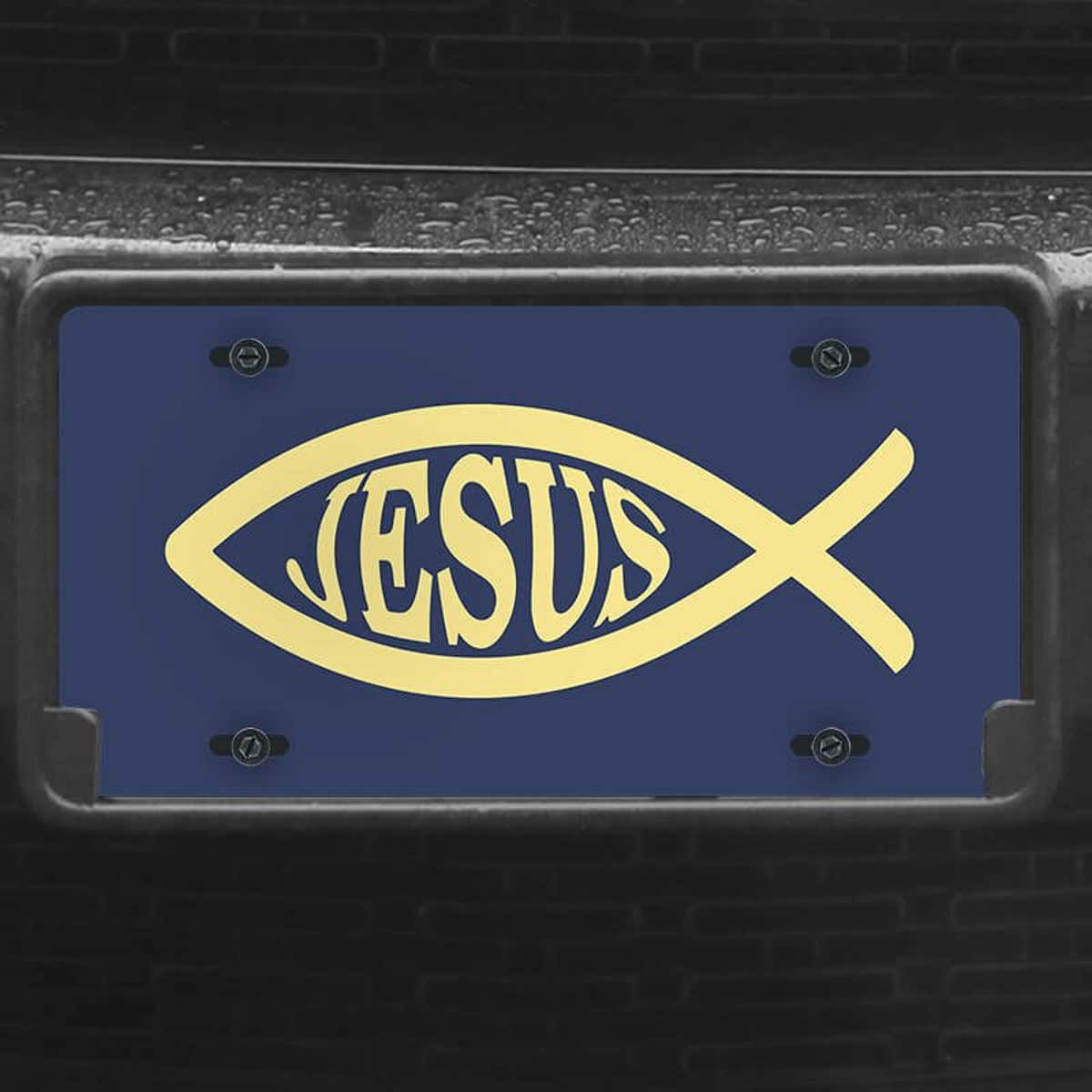 A close up of the Jesus Fish Ichthys front license plate on a black car