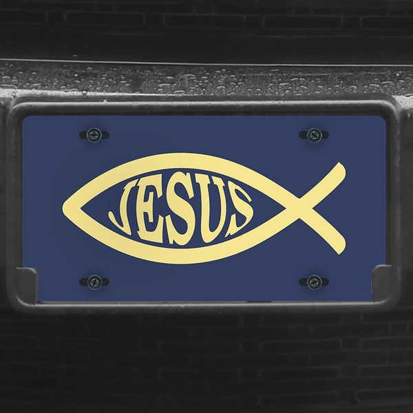 A close up of the Jesus Fish Ichthys front license plate on a black car