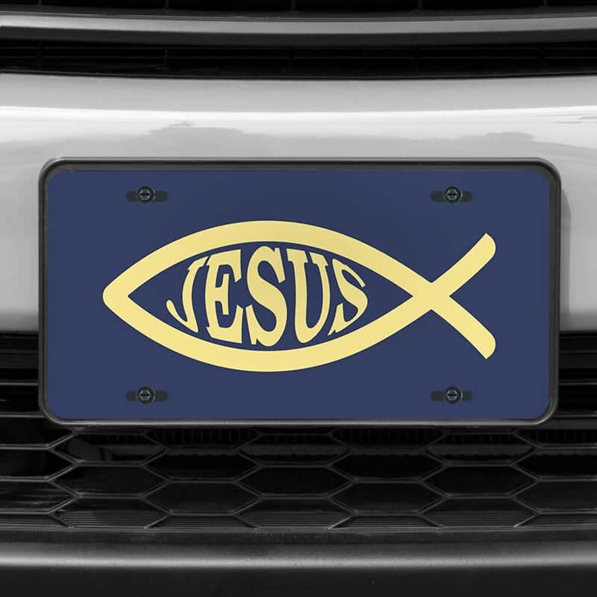 A close up of the Jesus Fish Ichthys front license plate on a white car