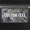 A close up of the Custom Military Camo front license plate on a black car