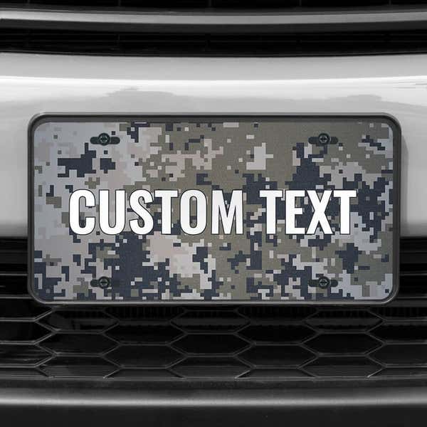A close up of the Custom Military Camo front license plate on a white car