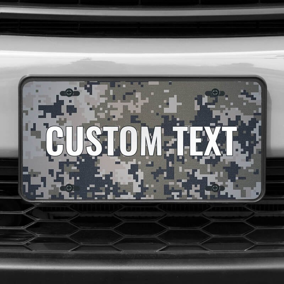 A close up of the Custom Military Camo front license plate on a white car