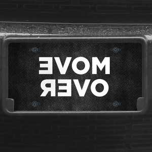 A close up of the Move Over front license plate on a black car