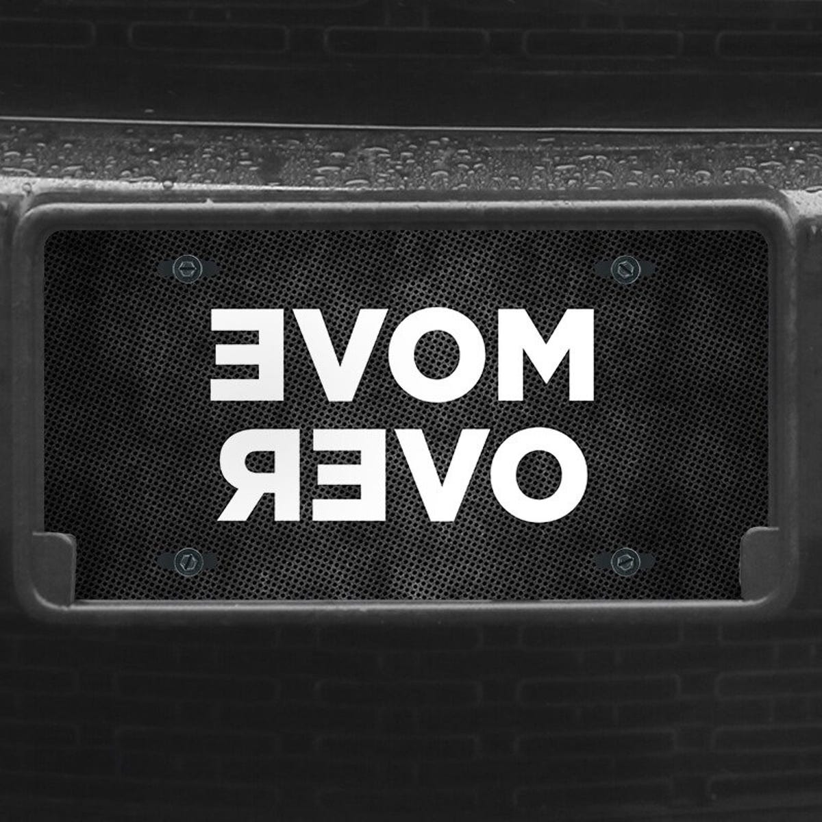 A close up of the Move Over front license plate on a black car
