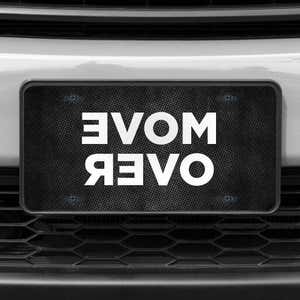 A close up of the Move Over front license plate on a white car