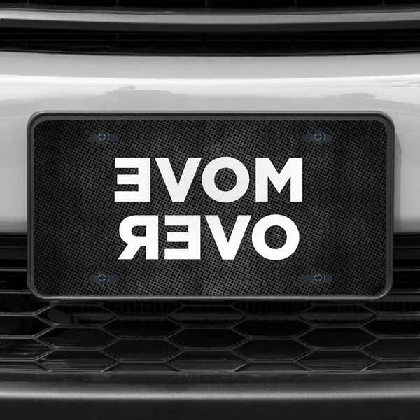 A close up of the Move Over front license plate on a white car