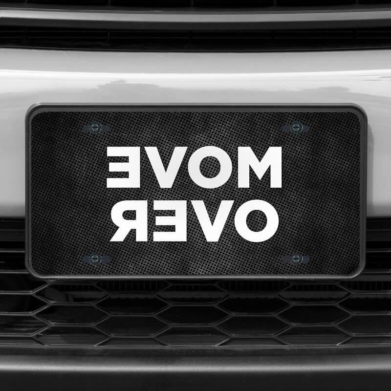 A close up of the Move Over front license plate on a white car