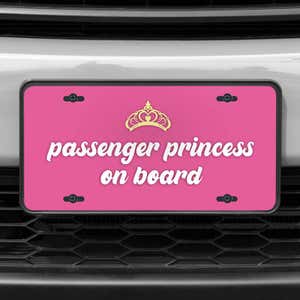 A close up of the Passenger Princess front license plate on a white car