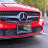 LGBTQ Pride American Flag front license plate on a red car