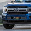 LGBTQ Pride American Flag front license plate on a blue truck