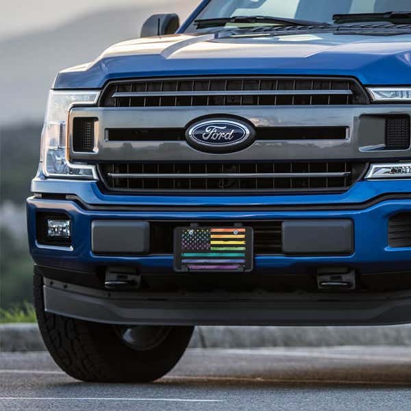 LGBTQ Pride American Flag front license plate on a blue truck