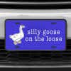 A close up of the Silly Goose front license plate on a white car