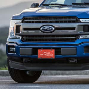 I Brake For Critters front license plate on a blue truck
