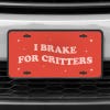 A close up of the I Brake For Critters front license plate on a white car