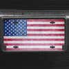 A close up of the American Flag Patriotic front license plate on a black car