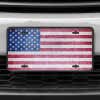 A close up of the American Flag Patriotic front license plate on a white car