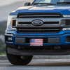 American Flag Patriotic front license plate on a blue truck