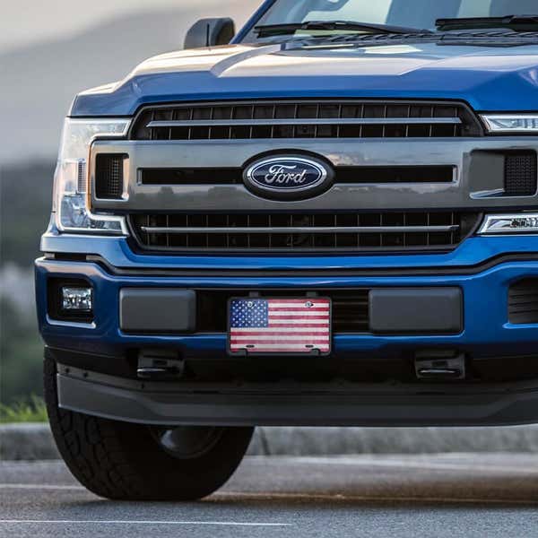 American Flag Patriotic front license plate on a blue truck