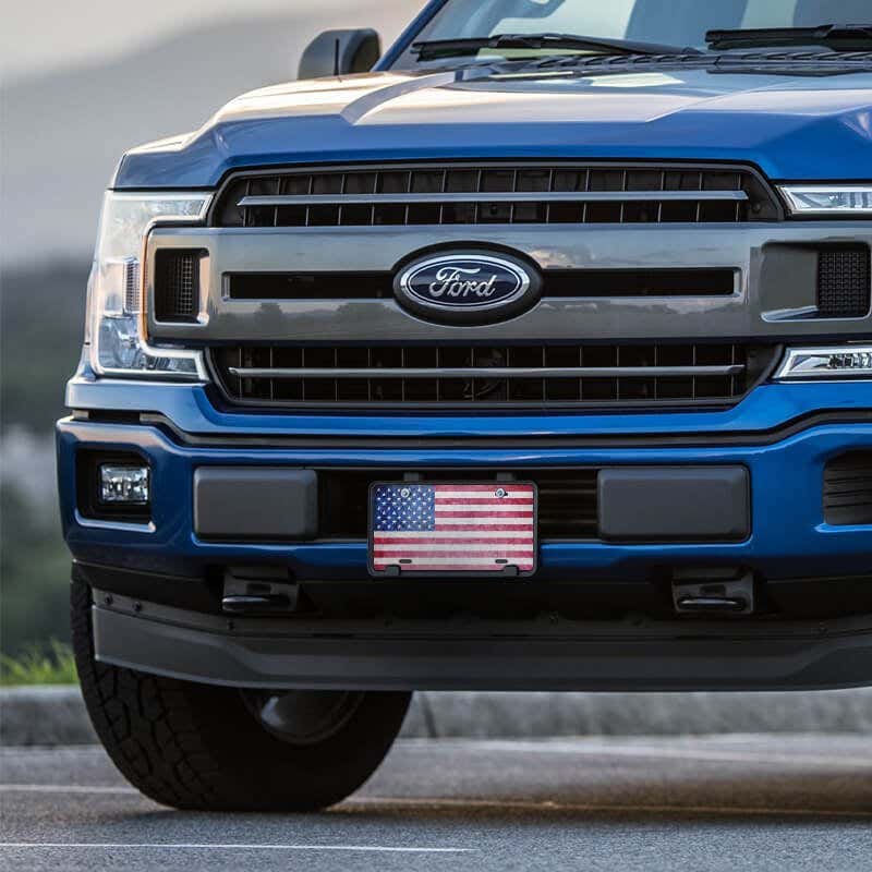 American Flag Patriotic front license plate on a blue truck