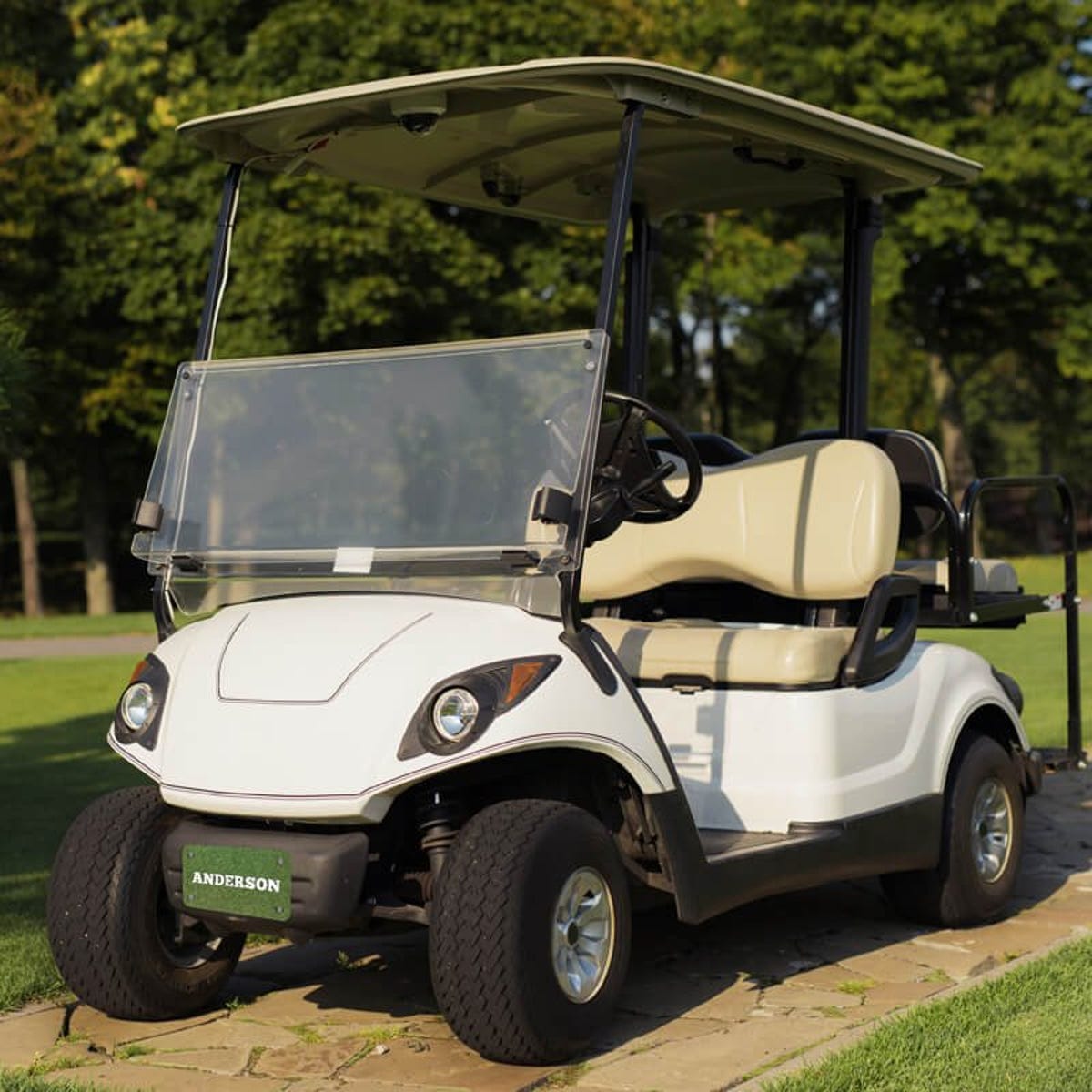 White Golf Cart with a Custom License Plate Saying "Anderson"