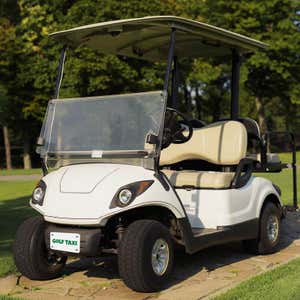 White Golf Cart with a Custom License Plate Saying "Golf Taxi"