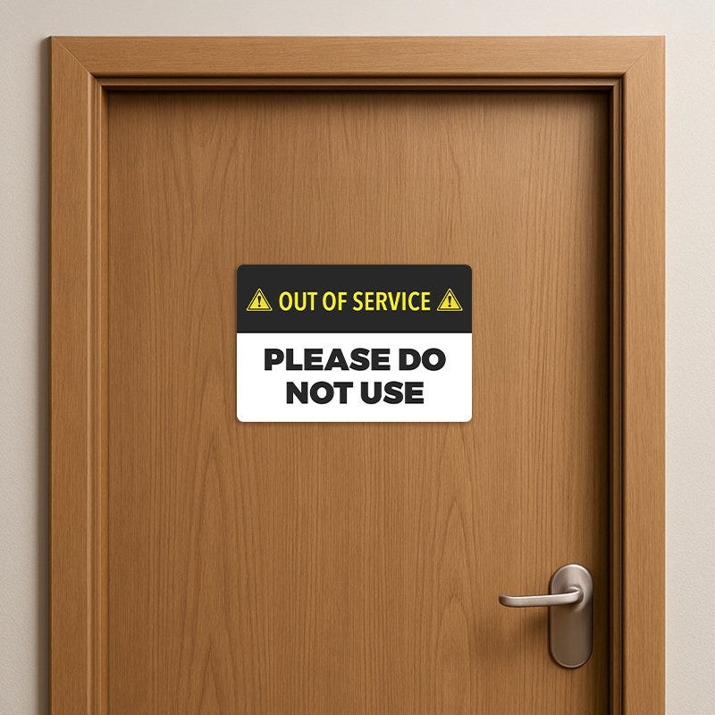Out of Service Sign on a wooden door