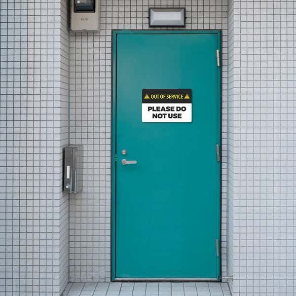 Out of Service Sign on a blue bathroom door