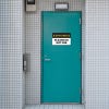 Out of Service Sign on a blue bathroom door