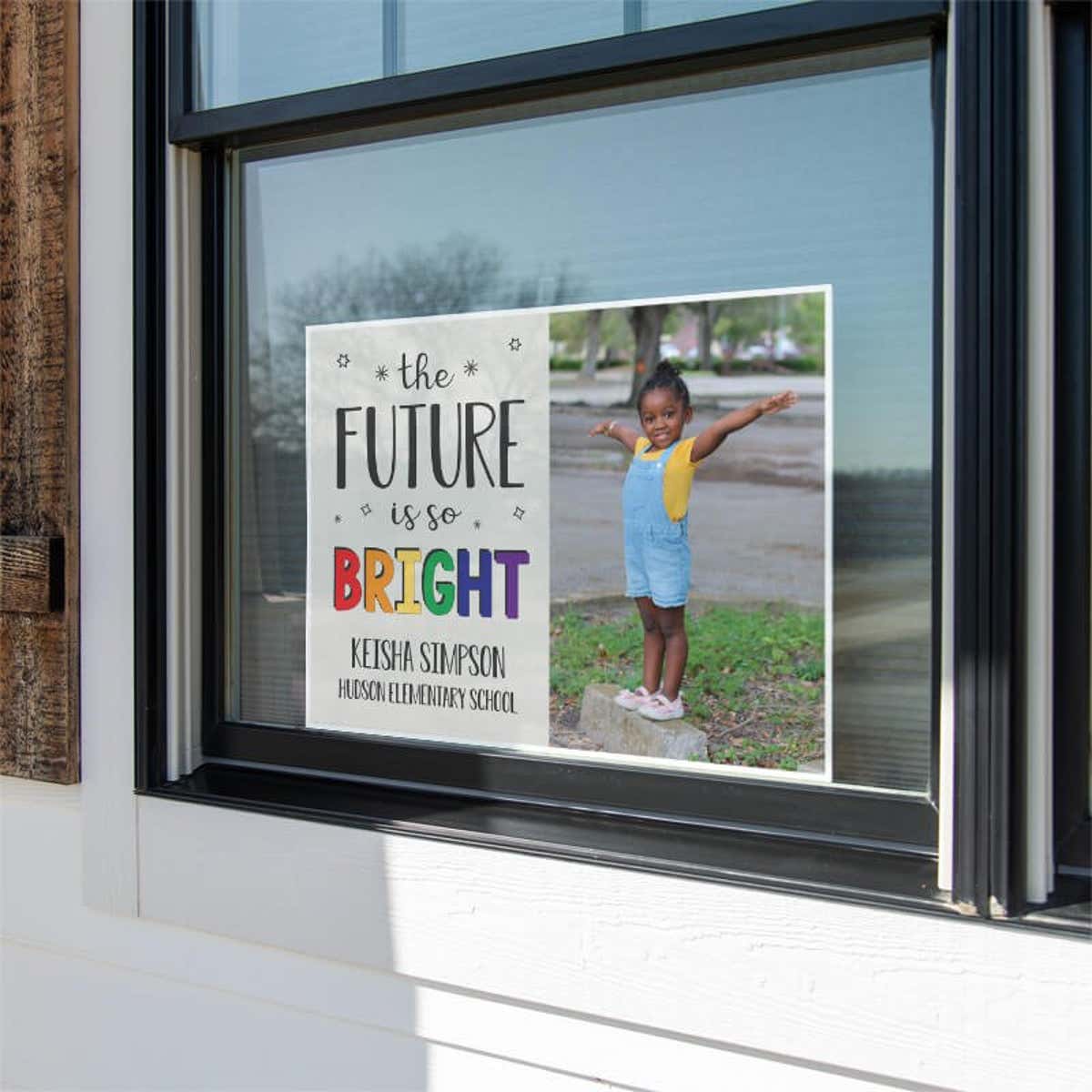 Future is bright graduation yard sign displayed in a window