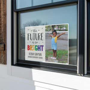 Future is bright graduation yard sign displayed in a window