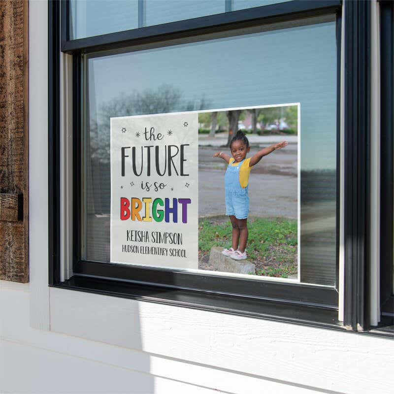 Future is bright graduation yard sign displayed in a window