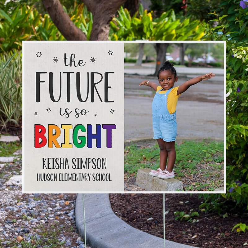 Future is bright graduation yard sign displayed next to pavement