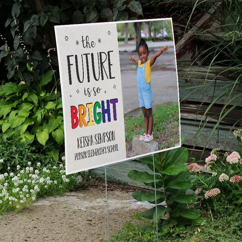 Future is bright graduation yard sign displayed next to stairs