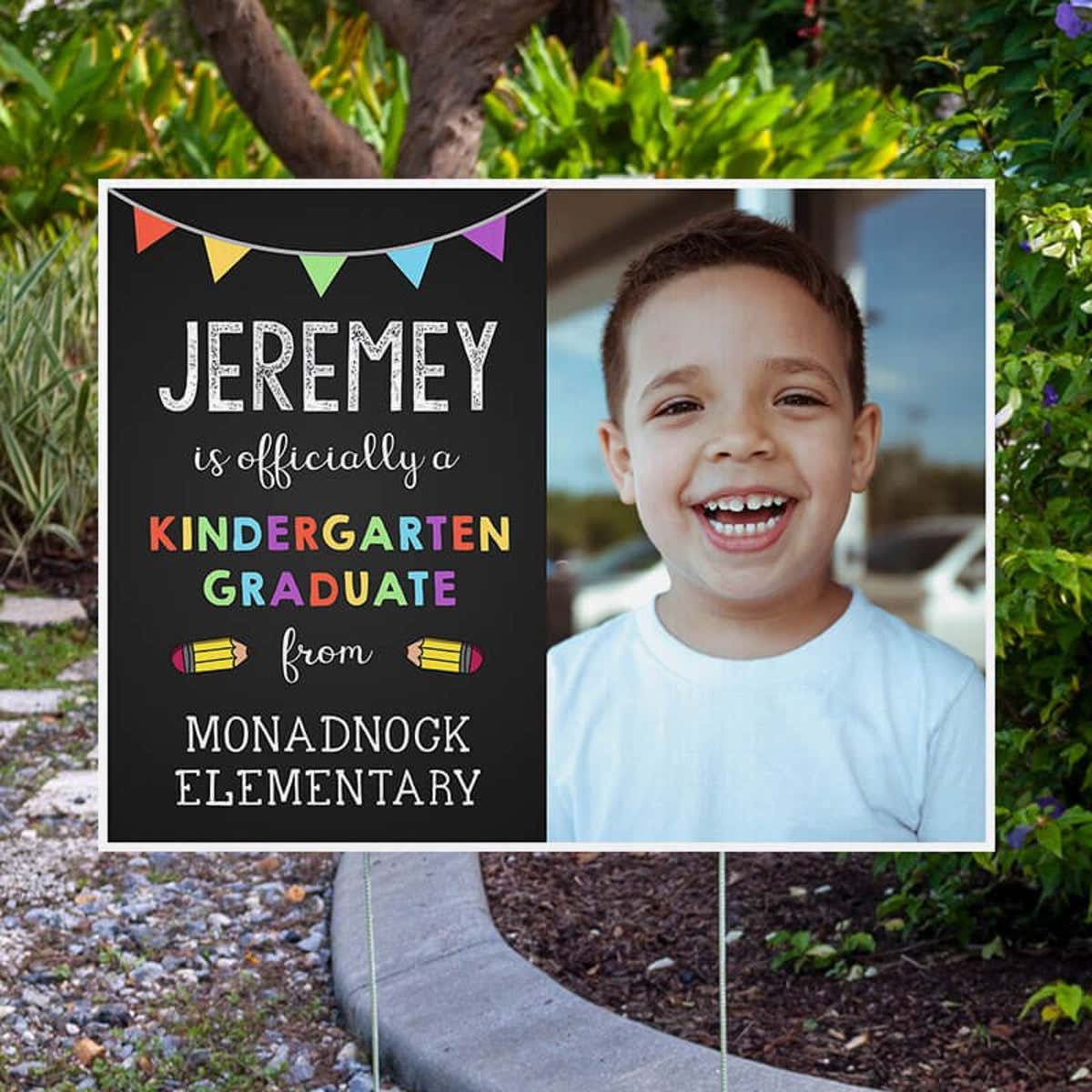 Officially a Kindergarten Graduate Graduation Yard Sign Next to Pavement