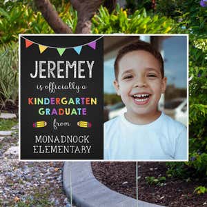 Officially a Kindergarten Graduate Graduation Yard Sign Next to Pavement