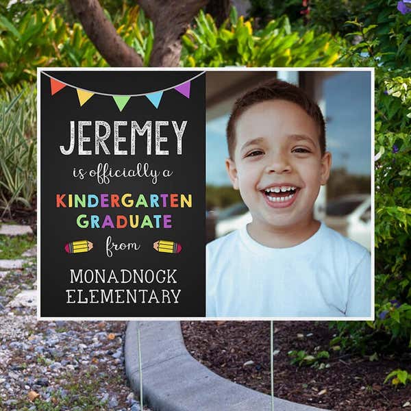 Officially a Kindergarten Graduate Graduation Yard Sign Next to Pavement
