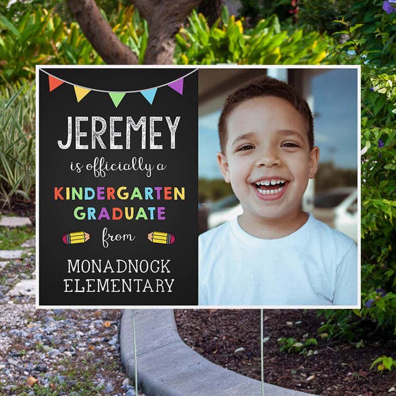 Officially a Kindergarten Graduate Graduation Yard Sign Next to Pavement