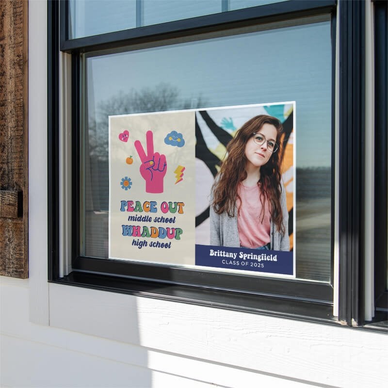 Peace out middle school graduation yard sign displayed in a window