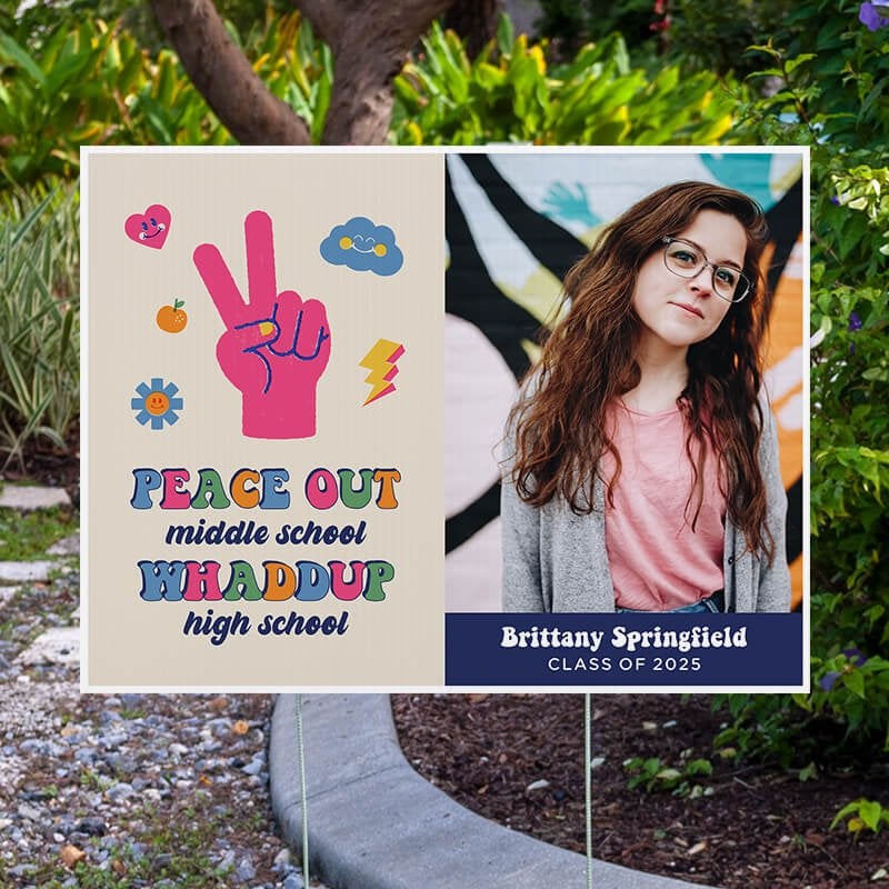 Peace out middle school graduation yard sign displayed next to pavement