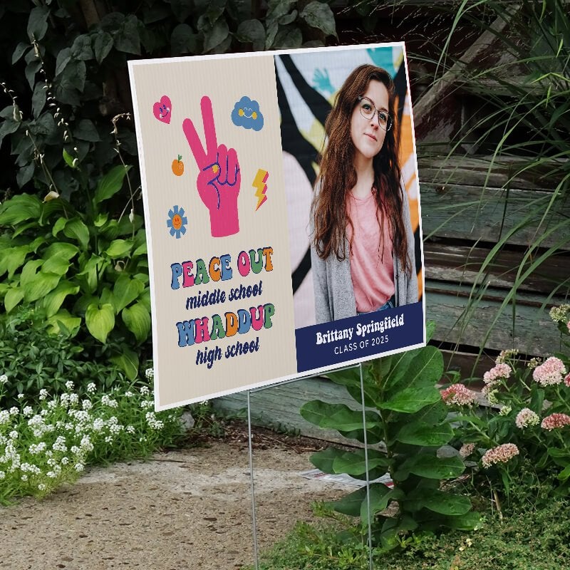 Peace out middle school graduation yard sign displayed next to stairs