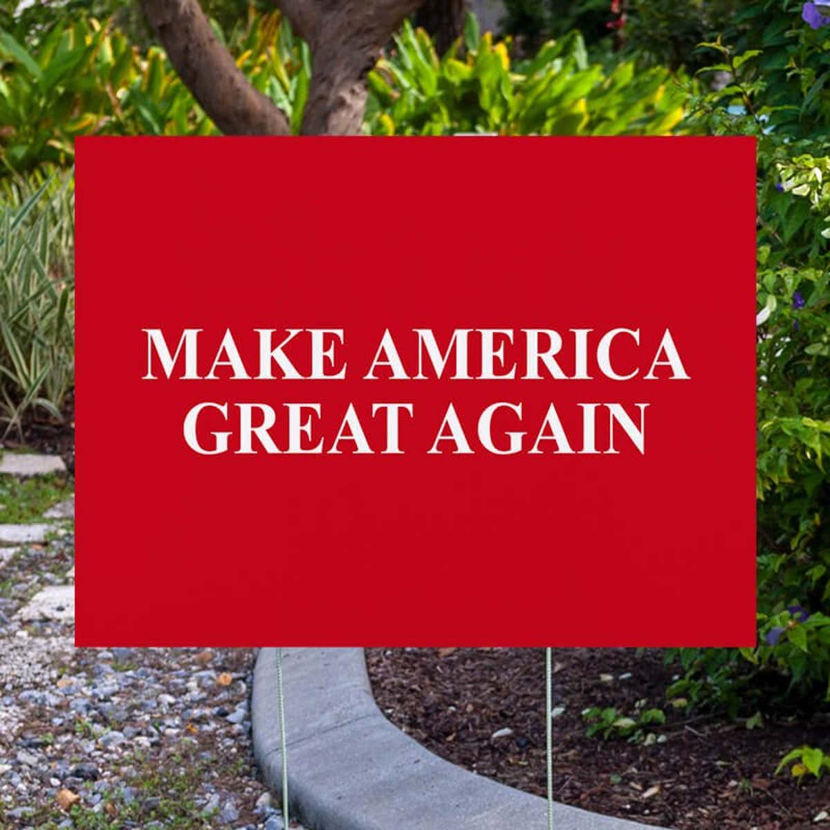 Maga yard sign next to pavement