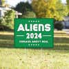 Aliens - Human Aren't Real Yard Sign in a Sunny Yard