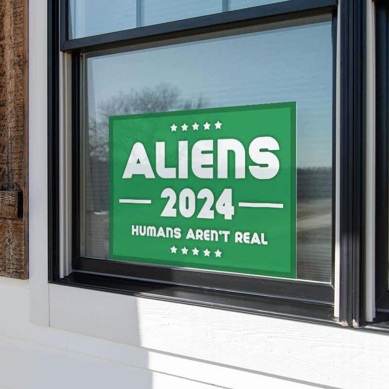 Aliens - Human Aren't Real Yard Sign in a Window
