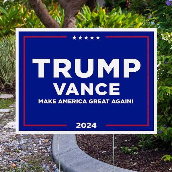 Trump Vance Blue Yard Sign next to pavement
