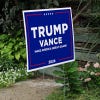 Trump Vance Blue Yard Sign next to stairs