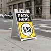 A $30 park here sandwich board sign displayed by a parking garage