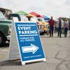 An event parking lot sandwich board for an exhibition displayed in a parking lot 