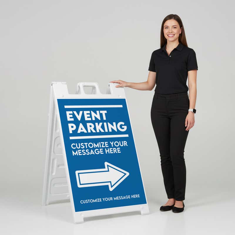 A woman standing next to an event parking A-frame sign with her hand on the top of the sign